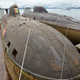 Two Akulas aboard a heavy-life vessel being transported from the Pacific for repairs. The Bratsk is on the left with Samara on the right. The size of the Akula is evidenced by the man in the lower right.